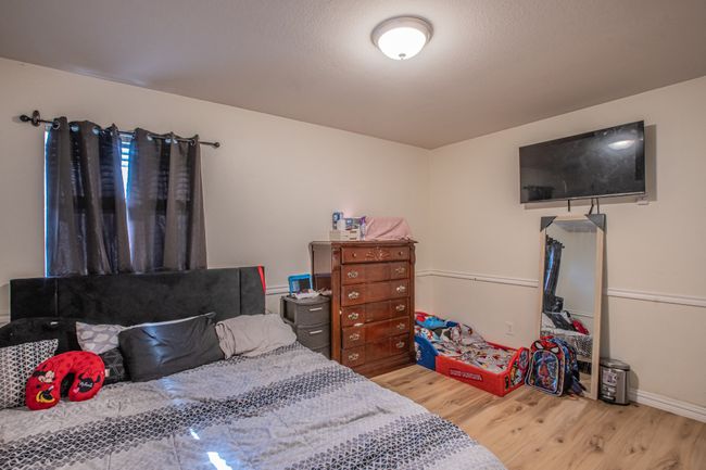 Bedroom with baseboards and wood finished floors | Image 27
