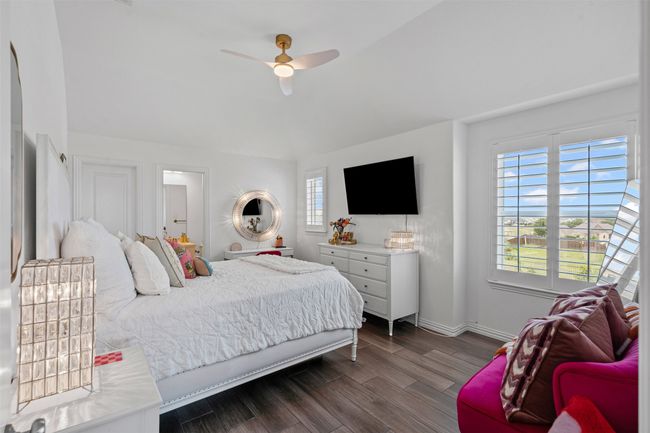 Bedroom featuring dark wood-type flooring, baseboards, and ceiling fan | Image 29