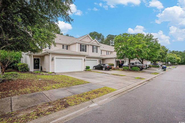 Townhome / multi-family property with a garage and driveway | Image 22