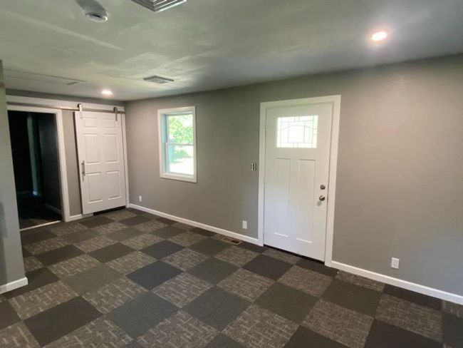 Tiled entryway featuring a barn door | Image 23