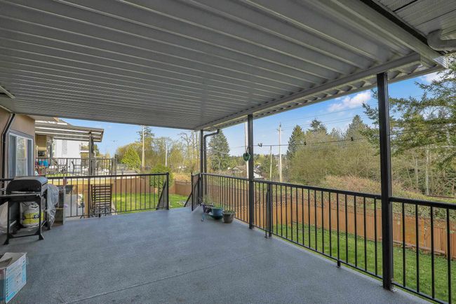 View of patio / terrace with a grill and fence | Image 36