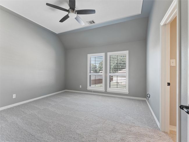 Unfurnished room featuring lofted ceiling, a ceiling fan, and carpet | Image 27
