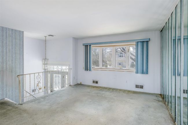 Spare room featuring visible vents and unfinished concrete flooring | Image 5