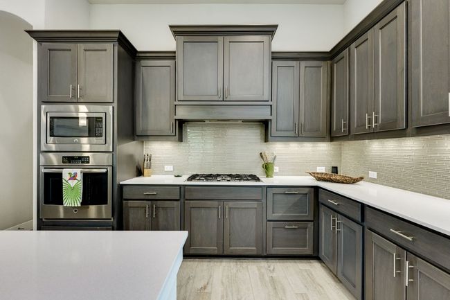 Kitchen featuring stainless steel appliances, light countertops, oversized island | Image 12