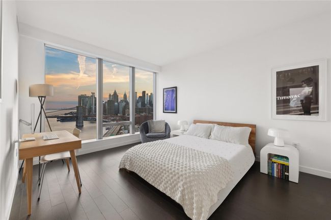 Bedroom with expansive windows, baseboards, and wood finished floors | Image 8