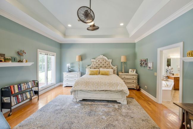 Master Bedroom with trey ceiling and gleaming hardwood floors | Image 19