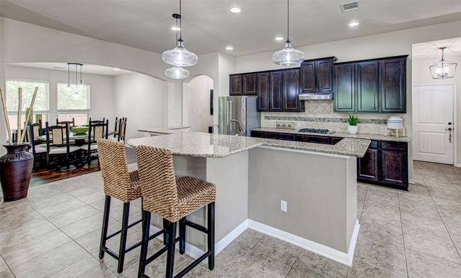 Enjoy the Elegance and Functionality of the Granite Island in this Beautifully Designed Kitchen, Ideal for Cooking and Gathering | Image 13