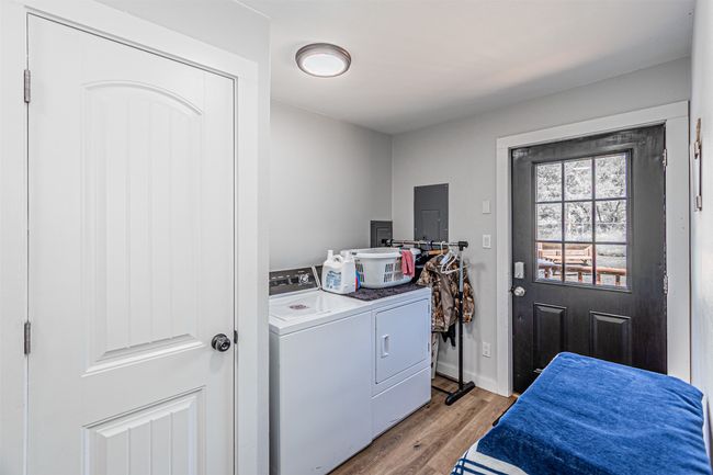 Laundry room with washer and dryer, light wood finished floors, and electric panel | Image 17