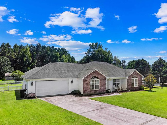 Single story home featuring brick siding, an attached garage, driveway, and roof with shingles | Image 17