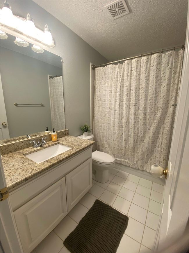 Full bath with toilet, a textured ceiling, visible vents, tile patterned flooring, and vanity | Image 26