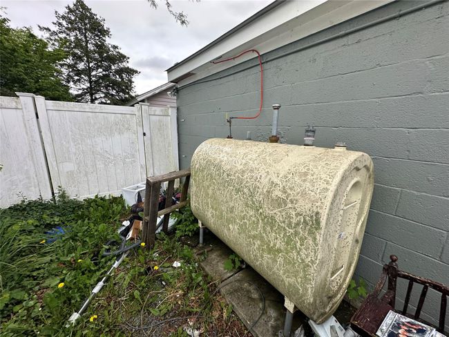 Exterior view of concrete block siding and heating fuel | Image 24