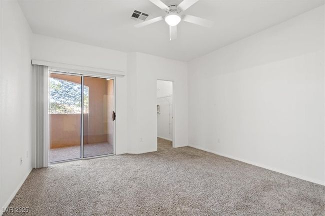 Unfurnished bedroom featuring visible vents, access to exterior, carpet, baseboards, and ceiling fan | Image 13