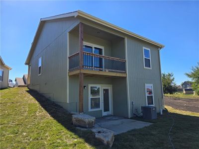 Back of property with a patio, a lawn, a balcony, and central AC | Image 2