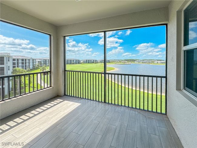 Unfurnished sunroom featuring a water view | Image 12