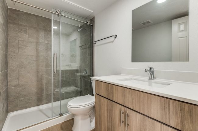 Bathroom featuring hardwood / wood-style floors, toilet, vanity, and walk in shower | Image 28