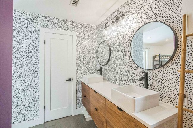 2nd primary bath with double vanity, quartz countertops and a walk-in closet | Image 22