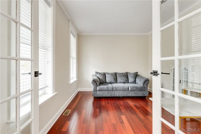 Sitting room featuring french doors, dark wood finished floors, baseboards, visible vents, and ornamental molding | Image 7