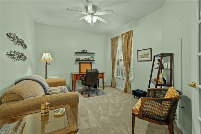Office with light colored carpet and ceiling fan | Image 16