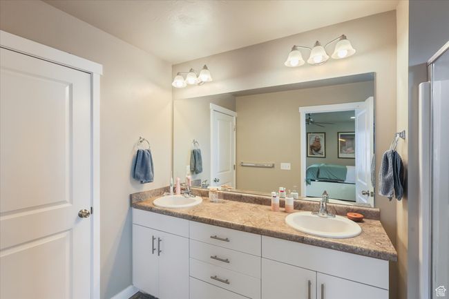 Ensuite bathroom with ensuite bathroom, a sink, double vanity, and a ceiling fan | Image 5