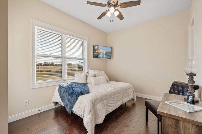 Main level bedroom suite with front yard views. | Image 14
