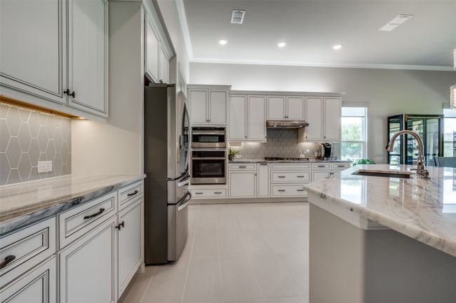 Kitchen featuring crown molding, tasteful backsplash, Dolomite counters | Image 8