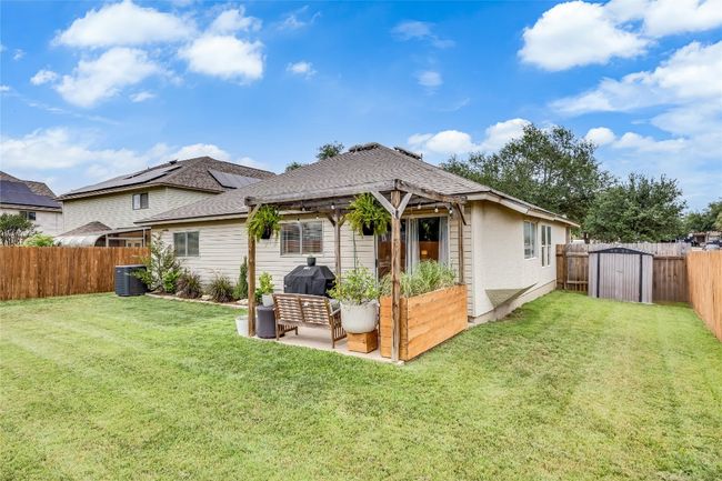 Rear view of property with outdoor lounge area, roof with shingles, a patio, and cooling unit | Image 29