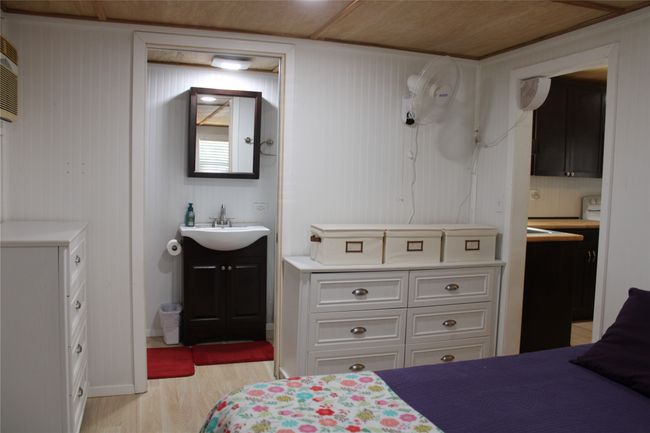 Bedroom featuring light wood finished floors and a sink | Image 7