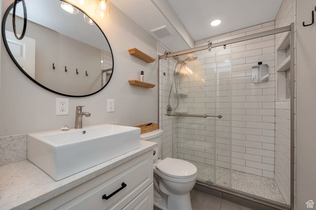 Bathroom featuring a shower stall, vanity, and recessed lighting | Image 10