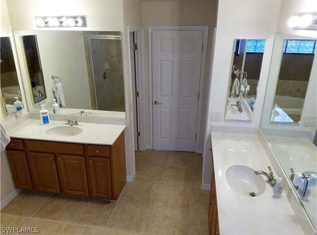 Master Bathroom with shower with separate bathtub, and His & Her sink vanities | Image 16