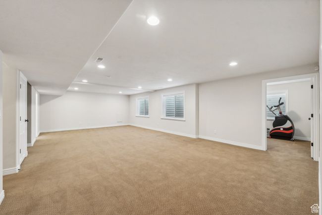 Basement with visible vents, light carpet, baseboards, and recessed lighting | Image 30