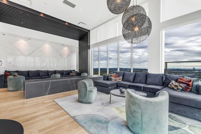 Living area featuring wood finished floors and a towering ceiling | Image 25