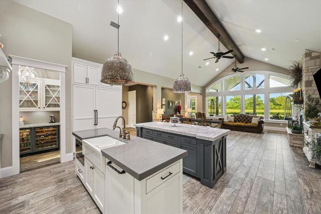 The kitchen opens to the living room, where you can enjoy picturesque views of the pond, frequently visited by cranes, ducks, and a variety of birdlife. The serene setting also attracts wildlife such as bald eagles, foxes, deer, bobcats, and raccoons, providing a front-row seat to nature’s beauty. | Image 10