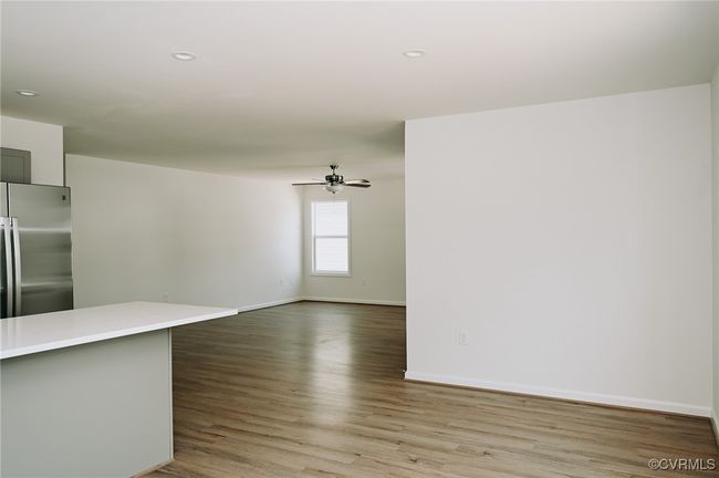 Unfurnished living room with hardwood / wood-style flooring and ceiling fan | Image 14