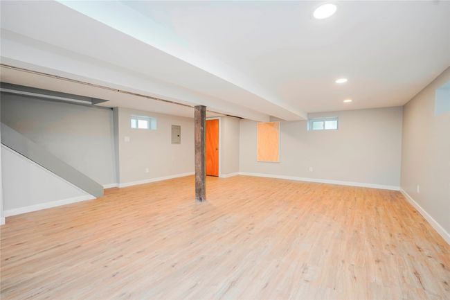Below grade area with baseboards, recessed lighting, light wood-style floors, and a healthy amount of sunlight | Image 21
