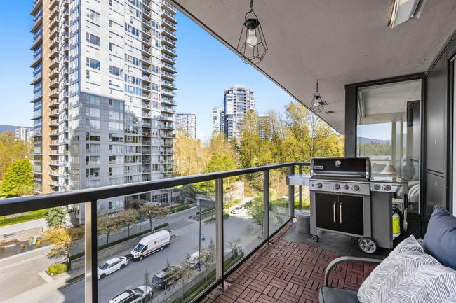 Balcony with grilling area and a view of city | Image 25