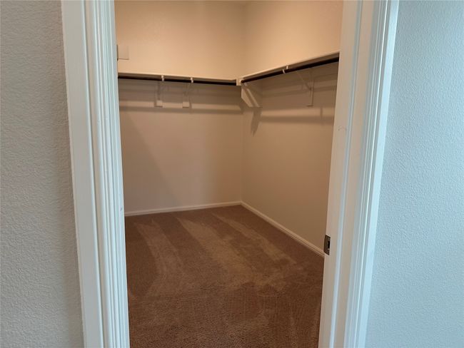Walk in closet featuring carpet flooring | Image 7