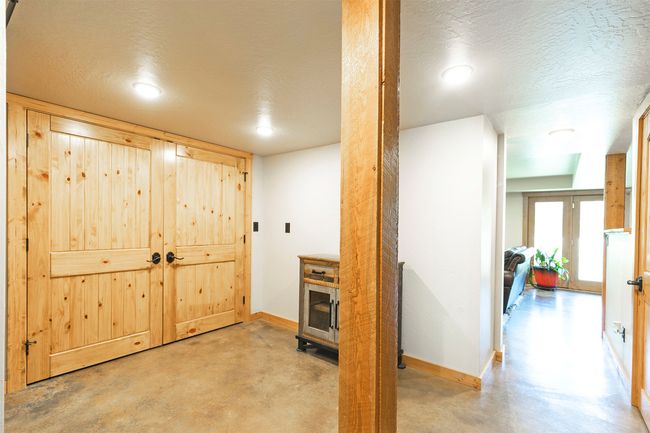 Basement area featuring concrete floors, baseboards, a textured ceiling, and recessed lighting | Image 34