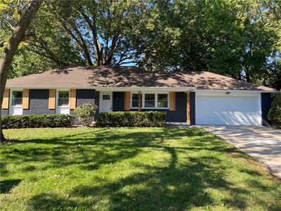 Single story home featuring a front yard and a garage | Image 1