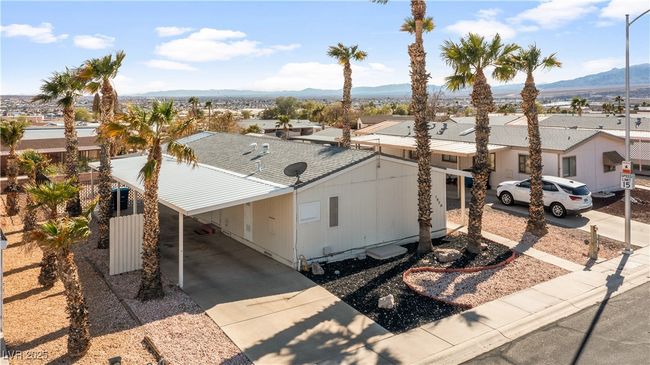 View of front of home with a carport, driveway, and a shingled roof | Image 63