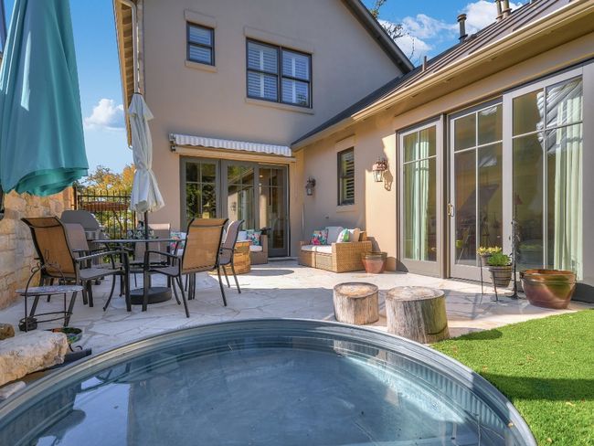 Rear view of house with a patio area, stucco siding, a jacuzzi, outdoor dining space, and french doors | Image 25