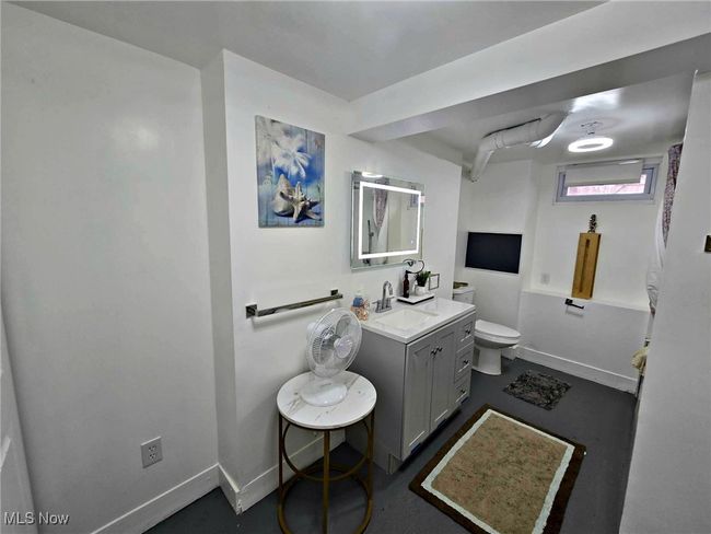 Full bath featuring toilet, vanity, and baseboards | Image 50