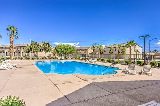 Community pool featuring a patio, fence, and a residential view | Image 33