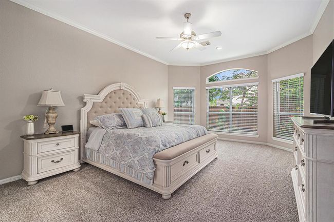 Welcome to your serene primary suite with a wall of windows and neutral tones makes nap time the best on a sunny fall afternoon! | Image 18