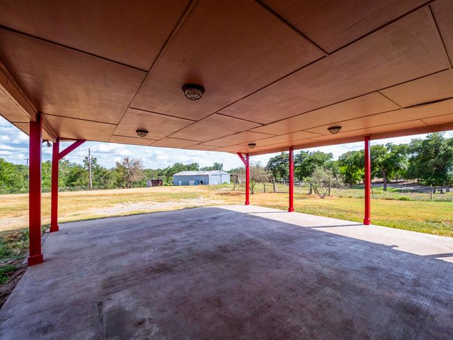 Two car attached carport with view of the barn. | Image 26