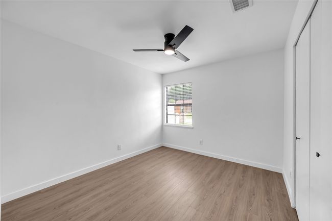 Unfurnished bedroom featuring light wood finished floors, a closet, baseboards, and a ceiling fan | Image 19