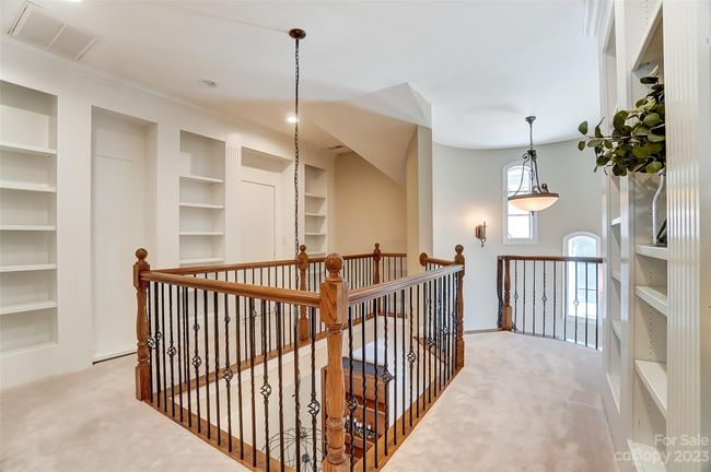 Upper level features built-in cabinetry, 3 spacious bedrooms, and bonus room | Image 22