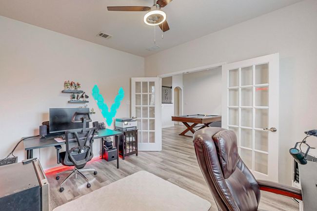 Office with french doors, arched walkways, a ceiling fan, and wood finished floors | Image 22