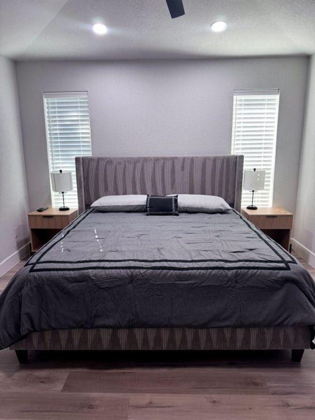 Bedroom featuring multiple windows, hardwood / wood-style floors, and ceiling fan | Image 10