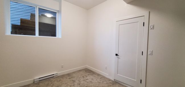 Spare room with baseboards, baseboard heating, and light carpet | Image 36