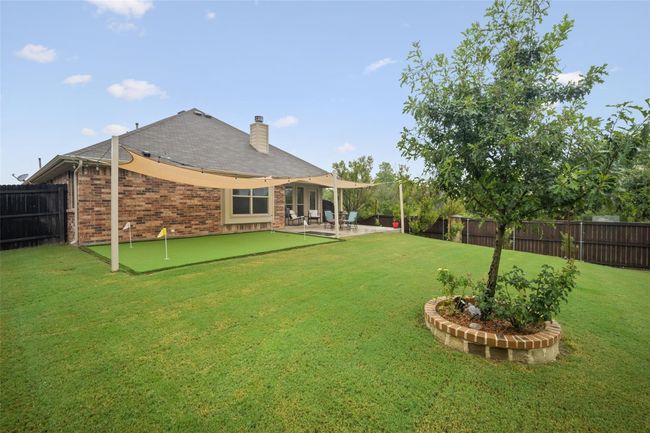 View of yard with a putting area and a patio area | Image 21